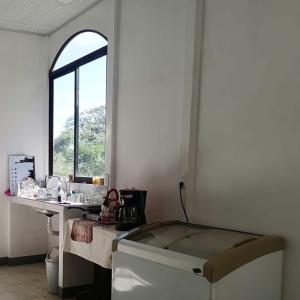 a white room with a sink and a window at Aura Living in La Garita +8 photos