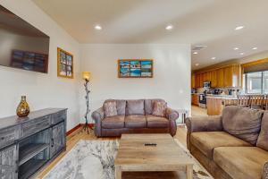 a living room with two couches and a table at No. 3 Coal Mine Cabin in Ronald