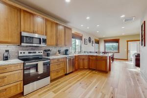 a large kitchen with wooden cabinets and stainless steel appliances at No. 3 Coal Mine Cabin in Ronald