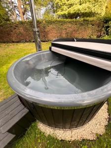 a bath tub with a toilet in the grass at Worcester Escape in Hallow