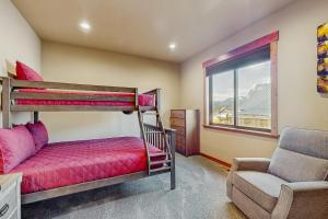 a bedroom with two bunk beds and a chair at No. 3 Coal Mine Cabin & Studio in Ronald