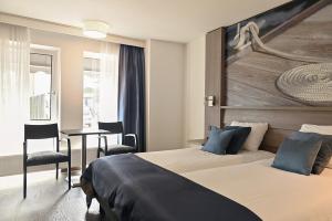 Ένα ή περισσότερα κρεβάτια σε δωμάτιο στο Hotel Medemblik