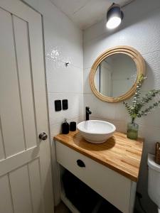 a bathroom with a sink and a mirror on a counter at Puerta Azul in Punta del Este