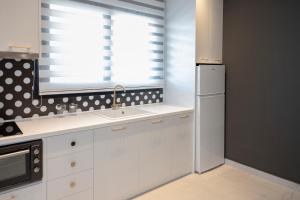 a kitchen with a sink and a window at The Loft Life in Tríkala +16 photos