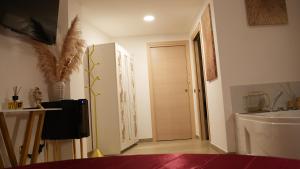 a room with a bathroom with a sink and a door at Monte d'Oro Rooms in Scauri