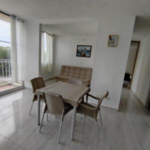 a living room with a table and chairs and a couch at Apartamento Completo en Ricaurte in Ricaurte