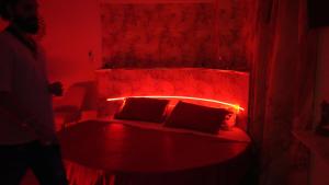 a red room with a bed with a red head board at Monte d'Oro Rooms in Scauri