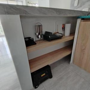 a shelf in a kitchen with a bunch of cooking utensils at Apartamento Completo en Ricaurte in Ricaurte +9 photos