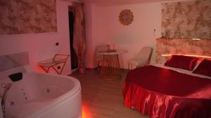 a bedroom with a tub and a bed and a bed and a bed at Monte d'Oro Rooms in Scauri