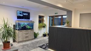 an office with a fish tank and a counter at Heathrow Travellers Hub in Hounslow