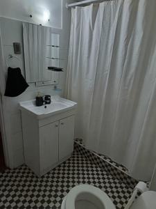 a bathroom with a white shower curtain and a toilet at GuestHouse Habitaciones SANTIAGO CENTRO in Santiago