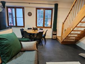 a living room with a couch and a table at Apartmán 19 MEZONET in Jáchymov