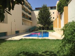 a swimming pool in the courtyard of a building at Casa Toboso 2 in Torre del Mar