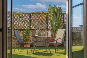a patio with a table and chairs on a balcony at Penthouse Station luxury apts Le dimore in Brindisi