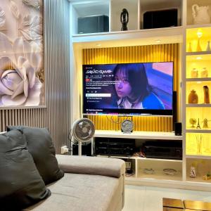 GuiguintoRelaxing 2BR Home Village Stay的客厅里墙上有一台大屏幕电视