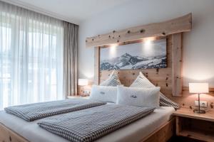 a bedroom with a large bed with a large window at Appartements Rosenhof in Pertisau