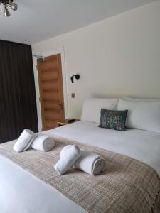 a bedroom with a bed with towels on it at Hidden Acres- Deluxe Double Room in Malahide