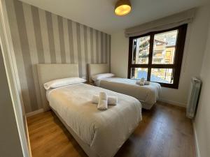 a room with two beds and a window at Villmor - B11 - Pichirillo in Benasque