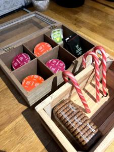 a wooden box with christmas cookies and candy canes at La vue sacrée in Laon