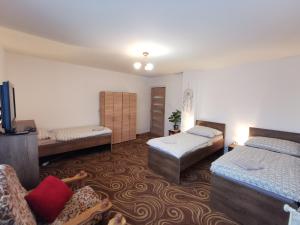 a room with three beds and a couch at Privat Teo Podtureň in Liptovský Mikuláš