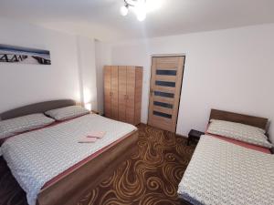 a bedroom with two beds and a small closet at Privat Teo Podtureň in Liptovský Mikuláš