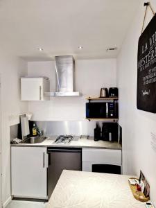 a small kitchen with a sink and a stove at SKY - Gîte meublé & confort Drôme - Écolodgîte in Laveyron