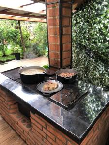 a grill with three bowls of food on a counter at Casa Haydee Monteverde in Monteverde Costa Rica +25 photos