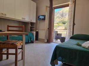 a bedroom with two beds and a table and a window at House Calamigna in Ventimiglia di Sicilia +82 photos