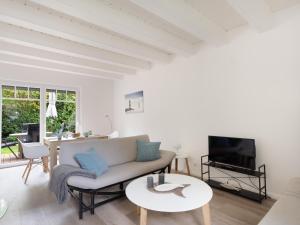 TV a/nebo společenská místnost v ubytování Ferienhaus Deich Huus