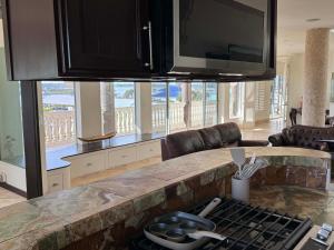 a kitchen with a counter with a stove top oven at Bliss By The Sea in Saint Augustine