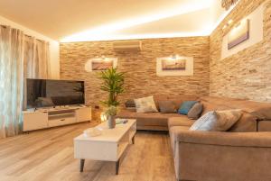 a living room with a couch and a flat screen tv at Attico Stella Maris in Palau