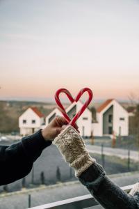 una persona che tiene in mano un oggetto rosso a forma di cuore di Moje Miejsce Polanica-Zdrój a Polanica-Zdrój