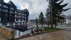 a building with a solarium on the side of it at Apartman Aska - Residence Hill in Kopaonik
