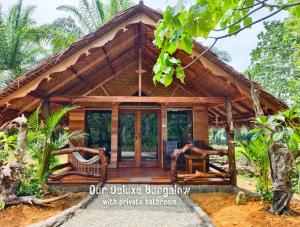 a house in the middle of a forest at TheJungleGuide - Lodges & Treks in Bukit Lawang