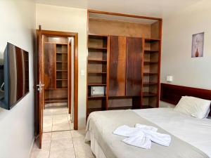 Ένα ή περισσότερα κρεβάτια σε δωμάτιο στο Boulevard da Praia Apart Hotel - Porto Seguro - Frente da Praia de Taperapuan