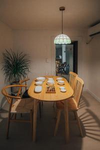a wooden dining room table with chairs and a light at 신흥부부공간a동 in Hamdŏng-ni