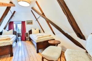 a attic room with two beds and a table at Riverside Apartments in Lübeck