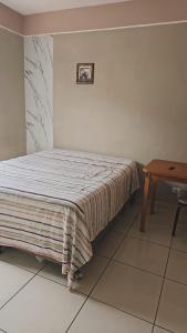 En eller flere senge i et værelse på Casa com dois quartos em Itanhaém