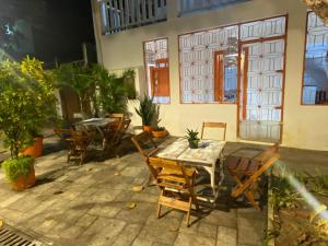 a patio with a table and chairs and a building at Xicabacana in Mata de Sao Joao +6 photos