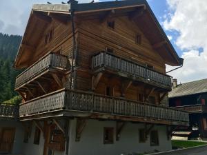 a large wooden building with balconies on it at Chesery 8 in Morgins
