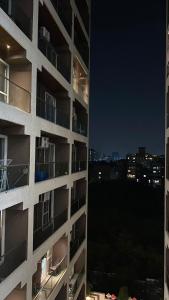 a tall apartment building at night with a city at Flat in Viman Nagar in Pune