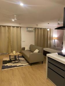 a living room with a couch and a bed at Flat in Viman Nagar in Pune