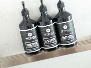a group of four black bottles sitting on a shelf at Grand Mercure Apartments Magnetic Island in Nelly Bay +131 photos