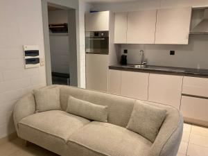 a living room with a couch in a kitchen at vakantie-hengelhoef in Houthalen-Helchteren +23 photos