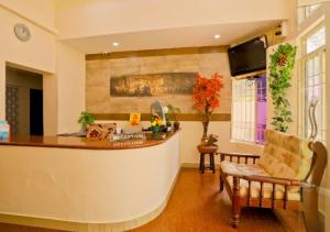 a living room with a bar and a chair at All Seasons Guest House in Trivandrum