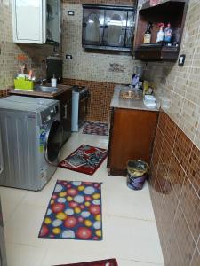 a kitchen with two rugs on the floor in a kitchen at Al Sharif Hotel Apartments in Abu Simbel