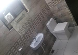 a bathroom with a toilet and a sink at All Seasons Guest House in Trivandrum