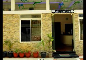a brick building with potted plants in front of it at All Seasons Guest House in Trivandrum +5 photos