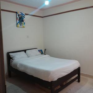 a bedroom with a bed in a room at Swali residence in Nakuru