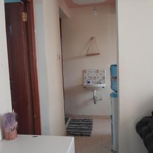 a bathroom with a sink in a room at Swali residence in Nakuru +6 photos